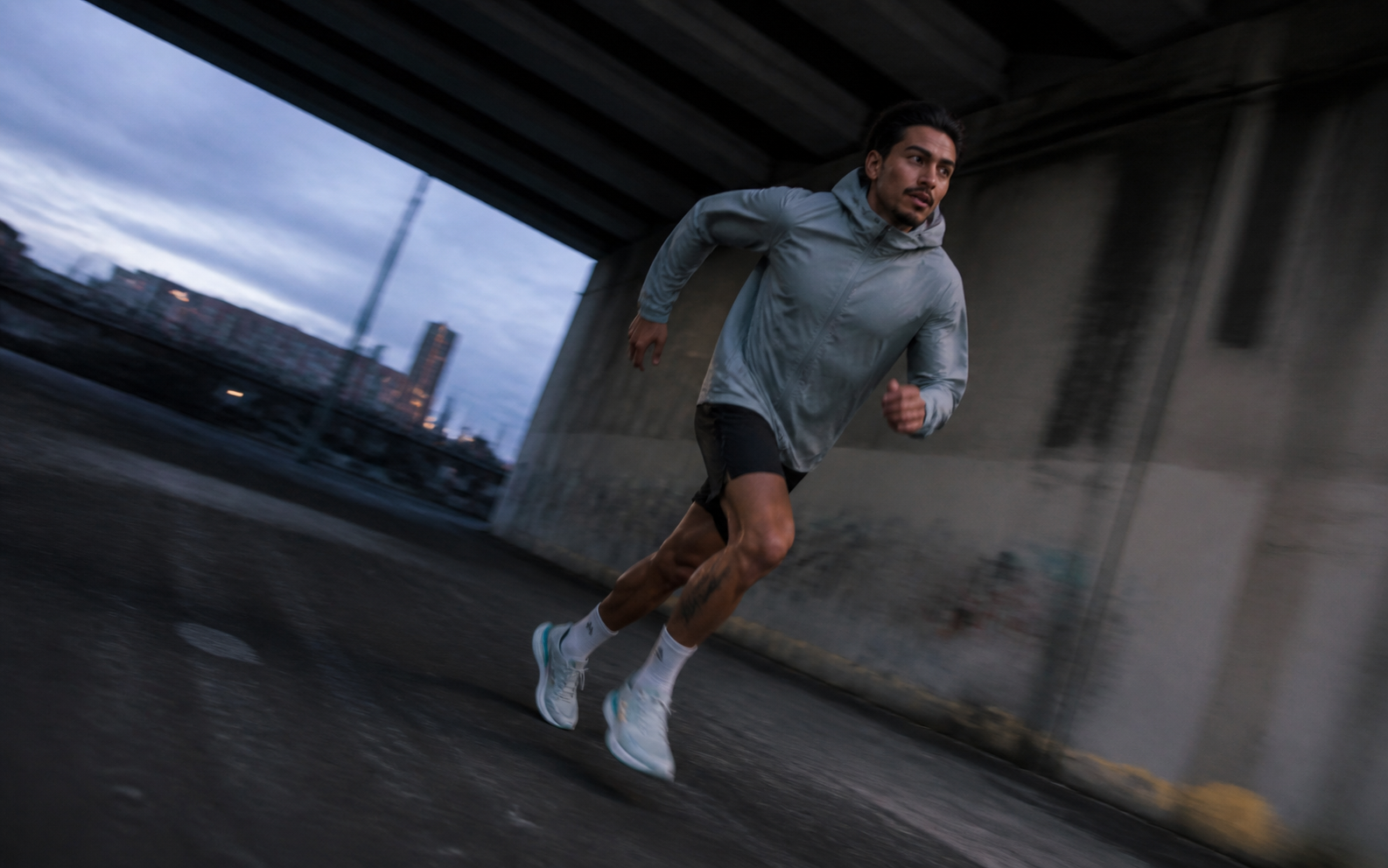 Runner turning beneath a concrete underpass